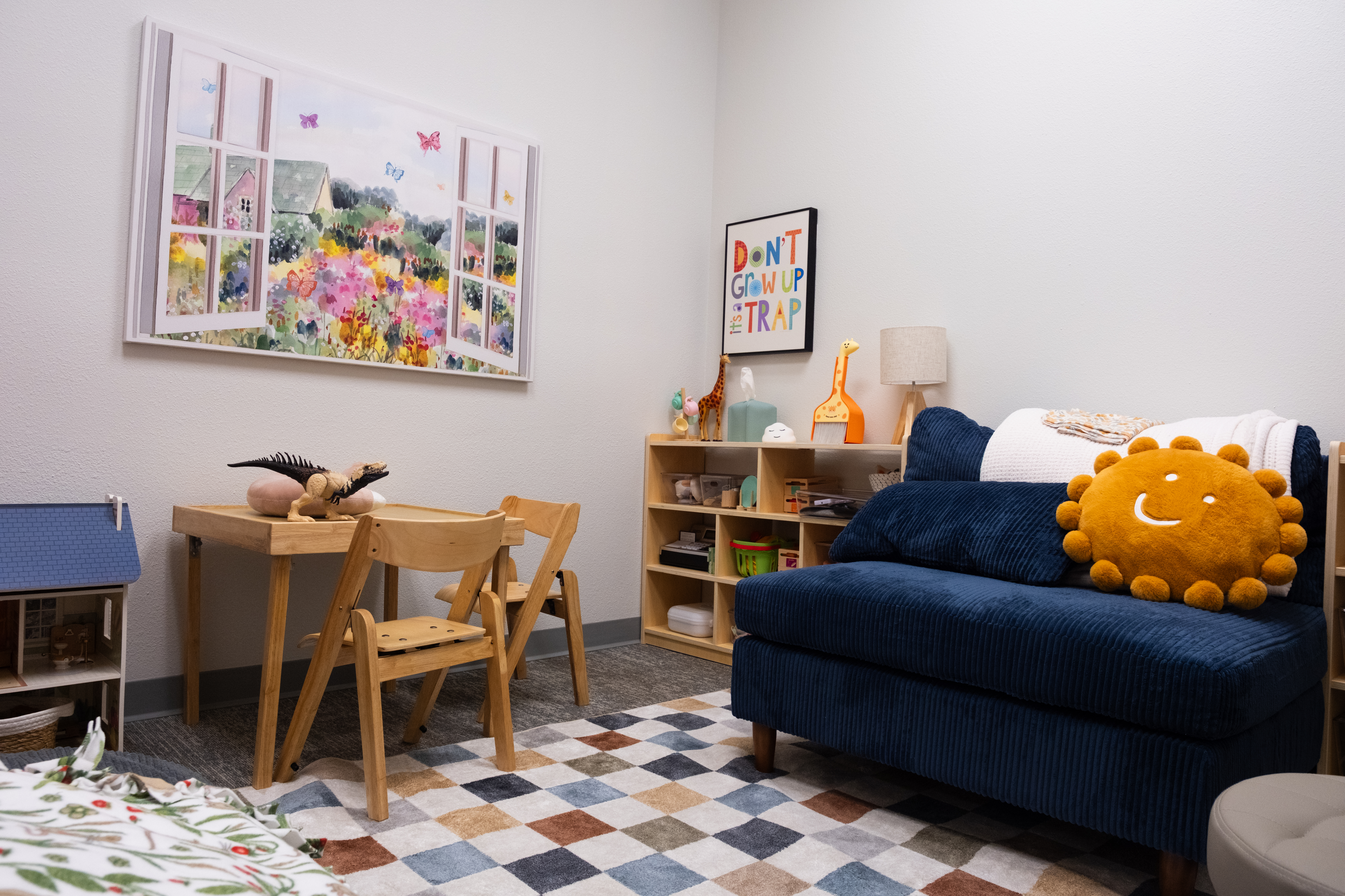 A quiet corner with cushions and sensory tools.
